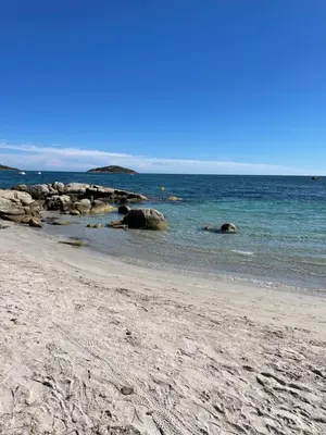 a beach with some rocks in the water at Chez Jeff Lucchini in Lecci