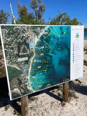 a sign with a map of the beach at Chez Jeff Lucchini in Lecci