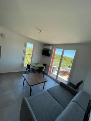 a living room with a couch and a table at Chez Jeff Lucchini in Lecci