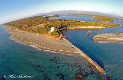 an island with a lighthouse in the water at Résidence Santa in Ghisonaccia