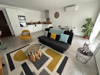 a living room with a couch and a table at Le Pélican T2 Magnifique in Ajaccio