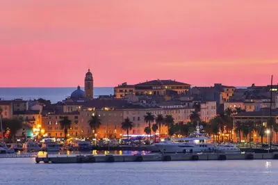 a city at night with boats in the water at Le Pélican T2 Magnifique in Ajaccio