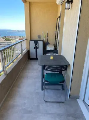 a balcony with a table and chairs on a balcony at Le Pélican T2 Magnifique in Ajaccio