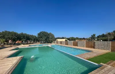 a swimming pool with a clear blue water at TRA MANNA in Lecci