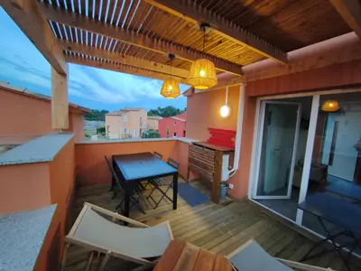 a patio with a table and chairs on a balcony at TRA MANNA in Lecci