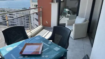 a table with a book on it on a balcony at T1 proche aéroport et plage in Ajaccio