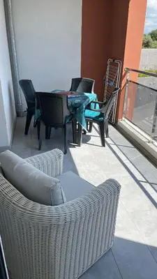 a patio with chairs and a table on a balcony at T1 proche aéroport et plage in Ajaccio