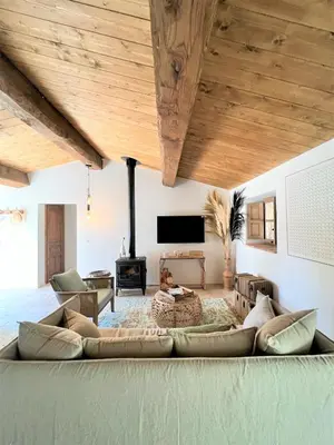 a living room with a couch and a tv at Casetta Tinuta in Sainte-Lucie de Porto-Vecchio