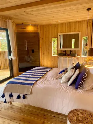 a bedroom with a large bed in a cabin at LES CABANES DE LUTINA in Poggio-Marinaccio
