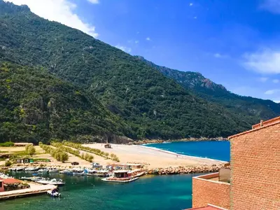a view of a beach and a body of water at Appartements Les résidences du port La Siesta in Porto Ota