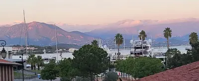 a view of a harbor with a boat in the water at Superbe T2 avec balcons, Vieux Port, Hyper centre Ajaccio in Ajaccio