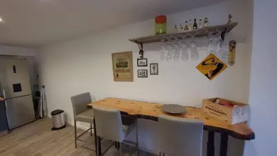a dining room with a wooden table and chairs at Superbe T2 avec balcons, Vieux Port, Hyper centre Ajaccio in Ajaccio