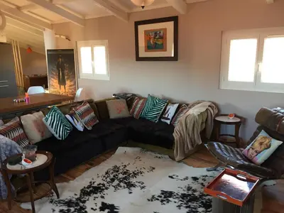 a living room with a black couch and two chairs at Small luxury loft, down Town Petit Loft (attique) in Ajaccio