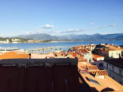 a city with a view of the water and buildings at Small luxury loft, down Town Petit Loft (attique) in Ajaccio