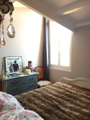 a bedroom with a bed and a dresser and a window at Small luxury loft, down Town Petit Loft (attique) in Ajaccio