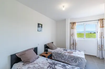 a bedroom with two beds and a window at Les Terres Rouges in Aléria