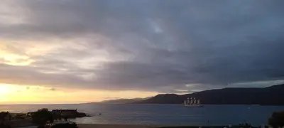 a sail boat in the water under a cloudy sky at face à la mer in Propriano