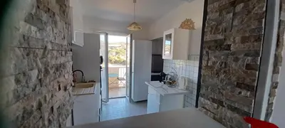a kitchen with a brick wall and a counter top at face à la mer in Propriano