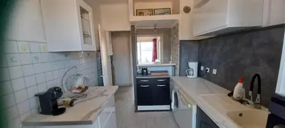 a kitchen with a sink and a counter top at face à la mer in Propriano