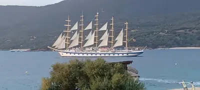 a large sail boat in a large body of water at face à la mer in Propriano