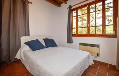 a bedroom with a white bed and a window at Lovely Home In Coti Chiavari With Wifi in Coti-Chiavari