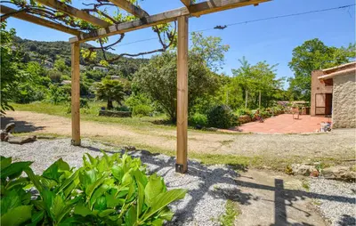 a view of a garden with a wooden pergola at Lovely Home In Coti Chiavari With Wifi in Coti-Chiavari
