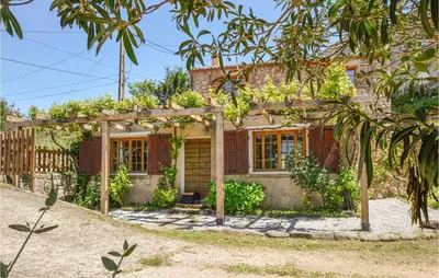 a house with a pergola in front of it at Lovely Home In Coti Chiavari With Wifi in Coti-Chiavari