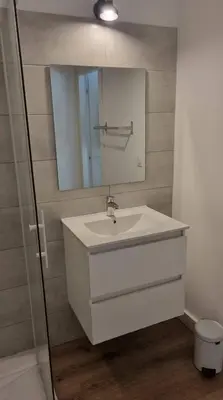 a bathroom with a white sink and a mirror at Fiori Di Cala Rossa Très beau studio au sein d'une résidence hôtelière avec piscine et plage Cala Rossa à 600m in Lecci