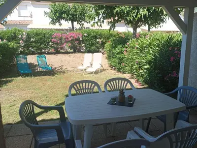 a white table and chairs on a patio at Villa climatisée A Nuciola Prunete Entre mer, montagne et piscine in Cervione
