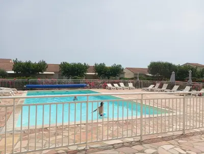 a swimming pool with a fence around it at Villa climatisée A Nuciola Prunete Entre mer, montagne et piscine in Cervione