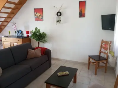 a living room with a couch and a table at Villa climatisée A Nuciola Prunete Entre mer, montagne et piscine in Cervione