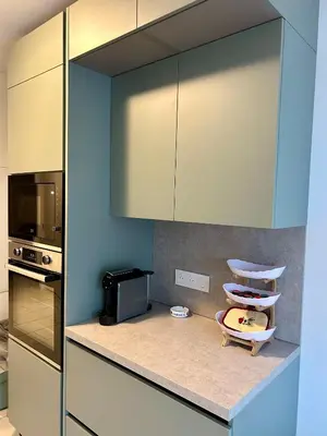 a living room with a door open to a balcony at Appartement centre ville avec piscine et vue mer in Sari Solenzara