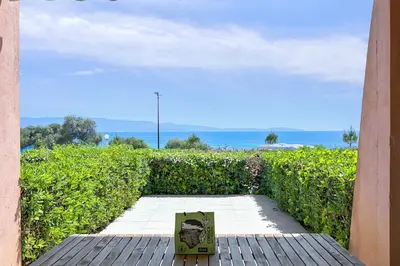 a pizza box sitting on a table in front of a hedge at Studio Rossi - Ajaccio - Welkeys in Ajaccio