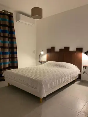 a bedroom with a large bed in a room at Gîte à la ferme chez Félix et Marie-Ca in Vallecalle