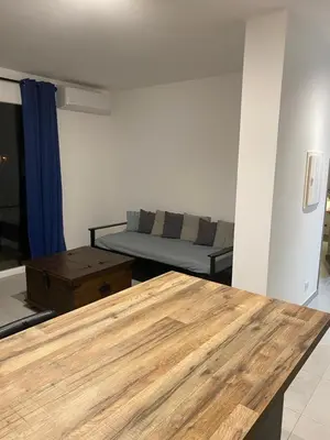 a living room with a table and a couch at Gîte à la ferme chez Félix et Marie-Ca in Vallecalle