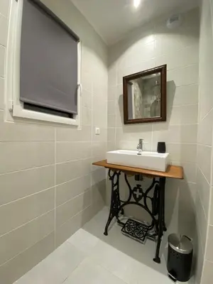 a bathroom with a sink and a mirror at Gîte à la ferme chez Félix et Marie-Ca in Vallecalle