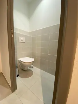 a bathroom with a white toilet in a room at Gîte à la ferme chez Félix et Marie-Ca in Vallecalle