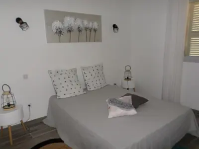 a bedroom with a bed and two side tables at Villa vue mer et nature route de Cigala in Sollacaro