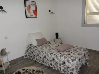 a bedroom with a bed in a room at Villa vue mer et nature route de Cigala in Sollacaro
