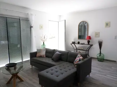 a living room with a couch and a table at Villa vue mer et nature route de Cigala in Sollacaro