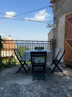 a table and two chairs sitting on a patio at Petit appartement à proximité de St Florent in Vallecalle