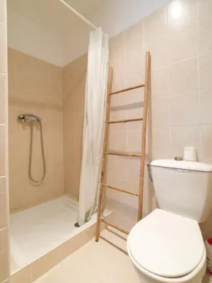 a bathroom with a shower with a toilet and a shower curtain at Petit appartement à proximité de St Florent in Vallecalle