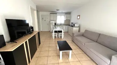 a living room with a couch and a table at Maison à Cervione Prunete jardin piscine accès direct plage in Cervione