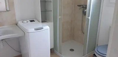 a small bathroom with a toilet and a shower at Maison à Cervione Prunete jardin piscine accès direct plage in Cervione