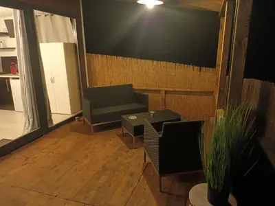 a living room with a couch and a table at U San Francescu Maisonette Modulaire Type studio in Volpajola