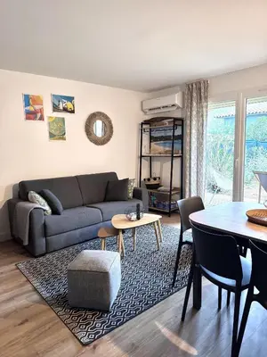 a living room with a couch and a table at Fiori di Cala Rossa résidence hôtelière in Lecci