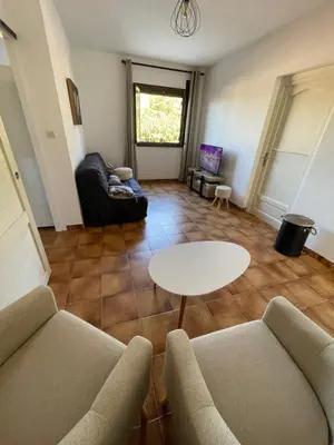 a living room with a couch and a table at Chez Caro in Sartène