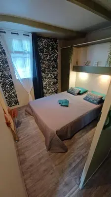 a bedroom with a large bed in a room at Le petit chalet d' Anto-Francè in Levie