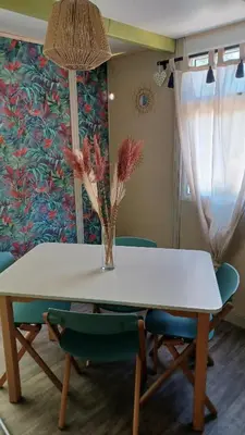 a table with a vase of flowers on top of it at Le petit chalet d' Anto-Francè in Levie