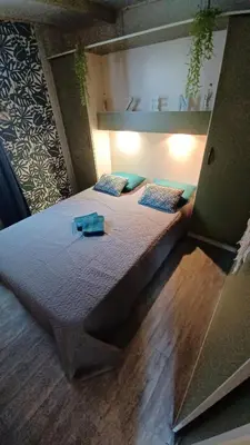 a large bed in a small room with at Le petit chalet d' Anto-Francè in Levie